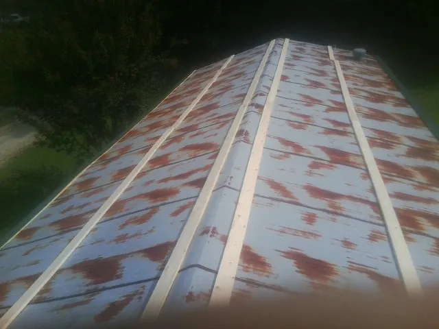Rusted metal roof panels with new wood purlins before replacement — Storm Damage Roof Repair in Vacaville by Roofing Brothers