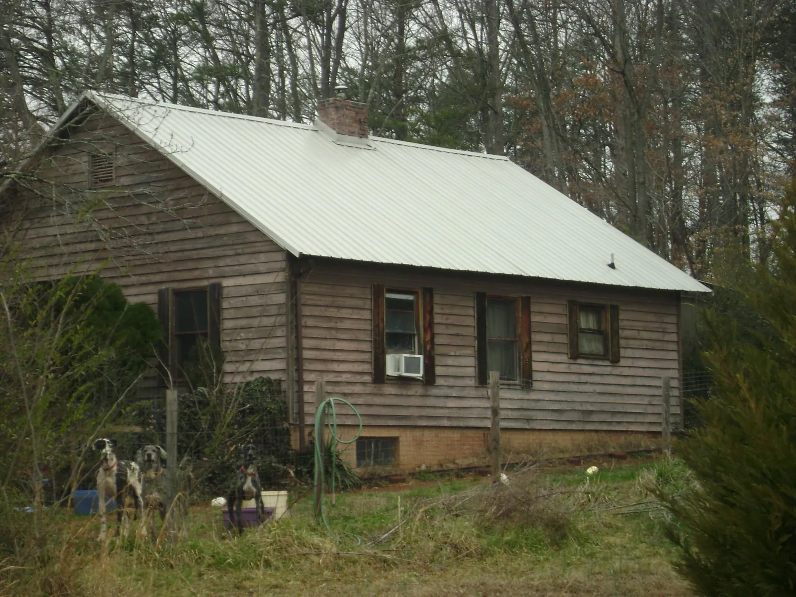 White metal roof on an old wood sided farmhouse, from a Metal Roof Installation job in Vacaville